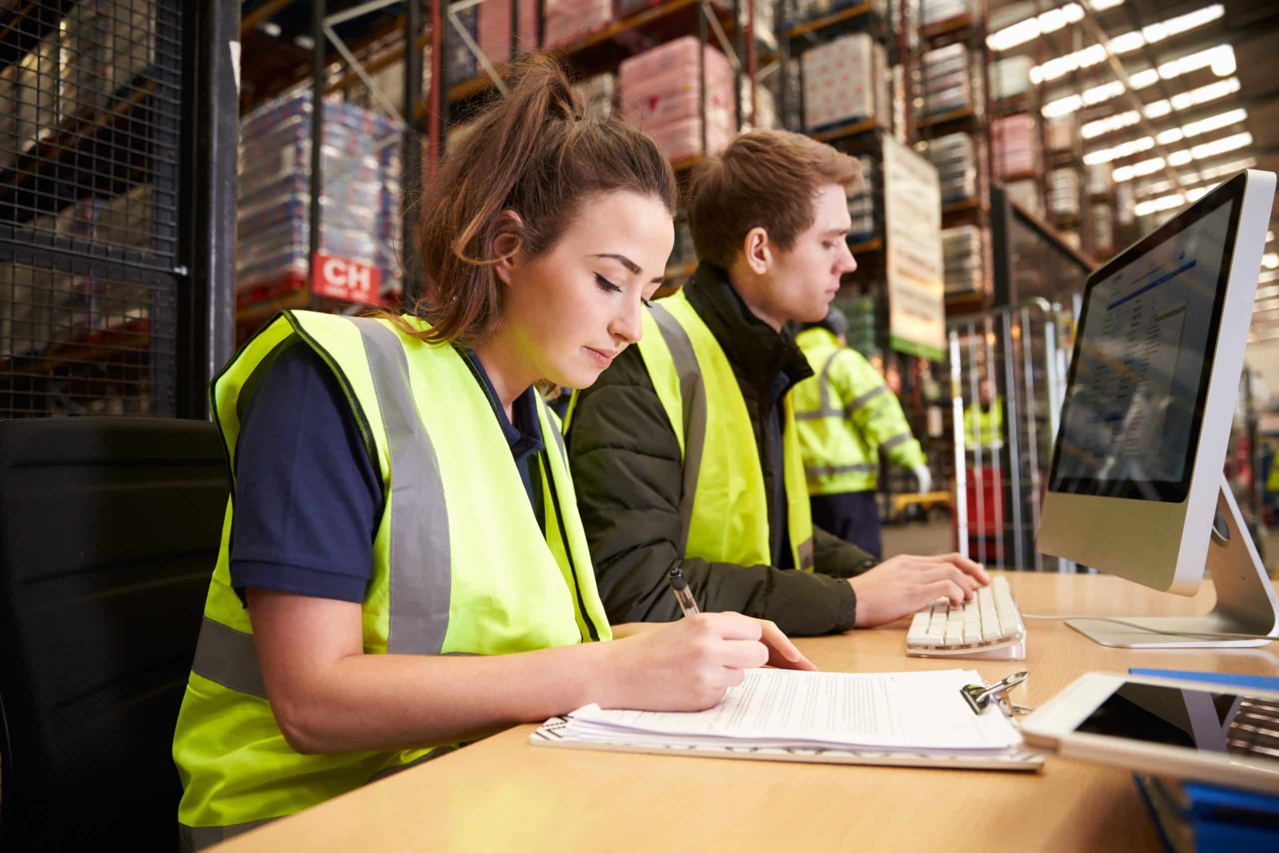 Staff managing warehouse logistics in an on-site office